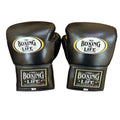 Pair of black boxing gloves with 'No Boxing No Life' branding on a wooden surface