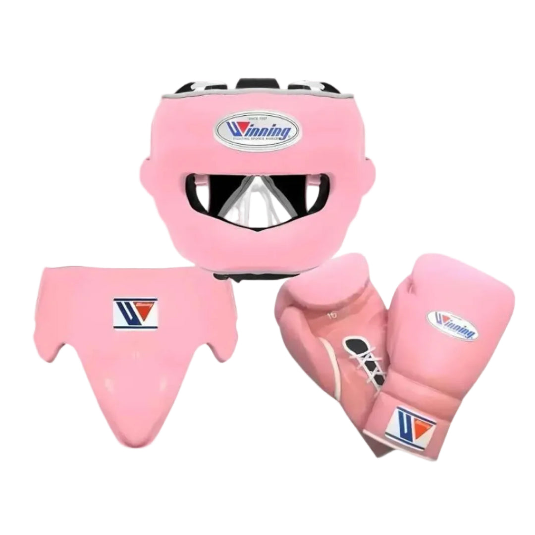 Pink boxing protective gear set including a headguard, chest guard, and boxing gloves, all branded with the Vinning logo, displayed on a light gray gradient background.