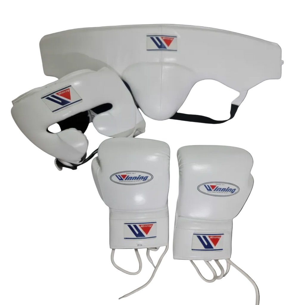White boxing gear set including a chin guard, headgear, and boxing gloves with the Winning brand logo, displayed on a dark background.