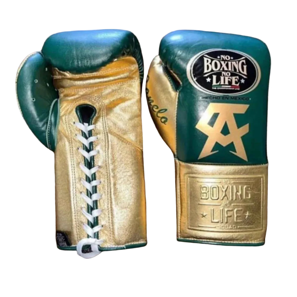 Pair of green and gold boxing gloves with branding on a wooden surface