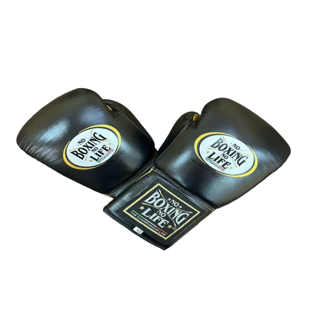 Pair of black boxing gloves with 'Boxing is Life' logo on a wooden surface