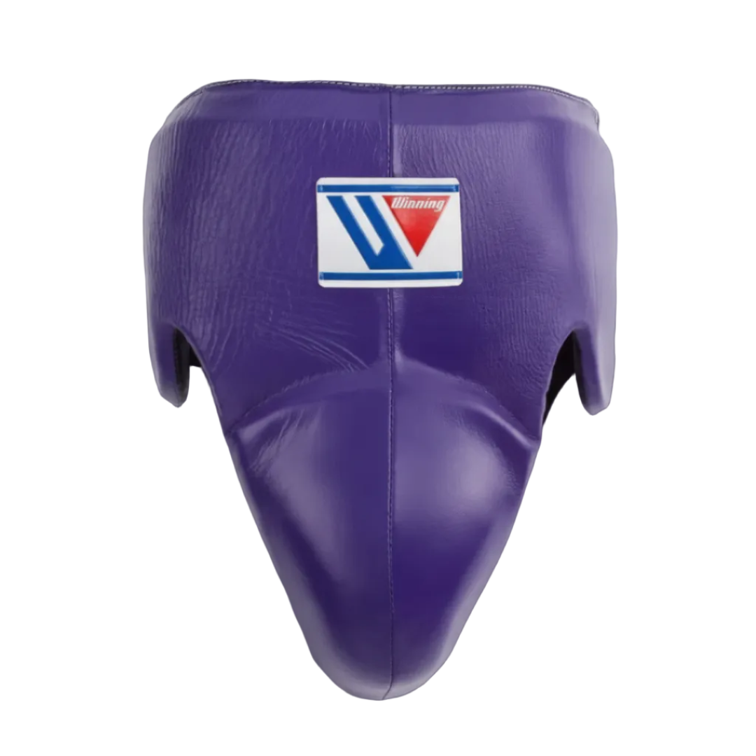 Purple leather shin guard with a white, blue, and red Venum logo patch on the forehead, shown against a dark gradient background.