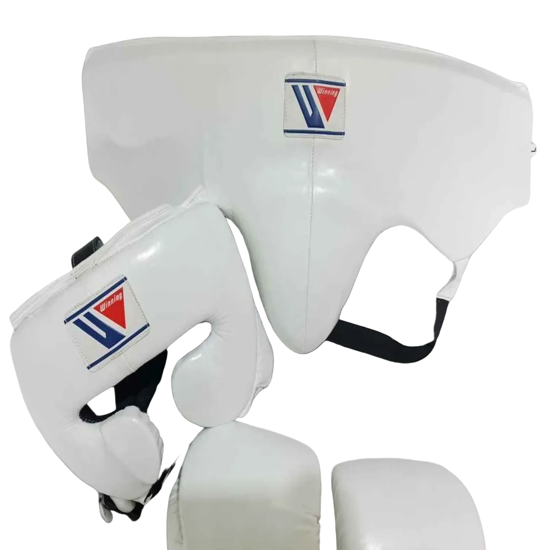 White boxing protective gear set including a chest guard, shin guards, and a head guard with a visible Venum logo patch, shown on a dark blue gradient background.