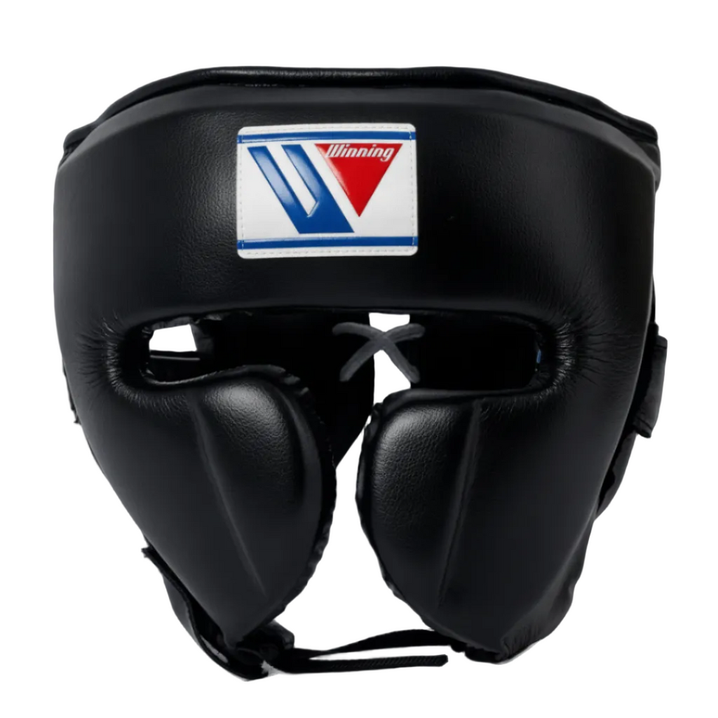 Black leather boxing headgear with a white, blue, and red Winning brand patch on the forehead, shown against a dark blue gradient background.