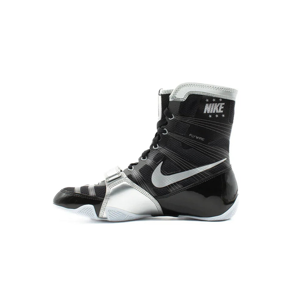 A Nike boxing boot in black and silver, featuring the Nike Swoosh and 'NIKE BOXING' branding on the ankle collar, shown against a plain white background.
