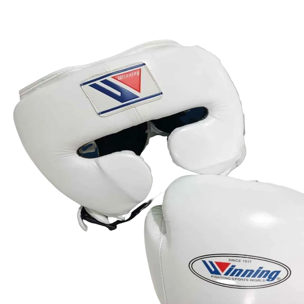 A set of red boxing protective gear including a pair of boxing gloves, a headguard, a chest guard, and a shin guard, all with the Winning brand logo, displayed against a dark background.