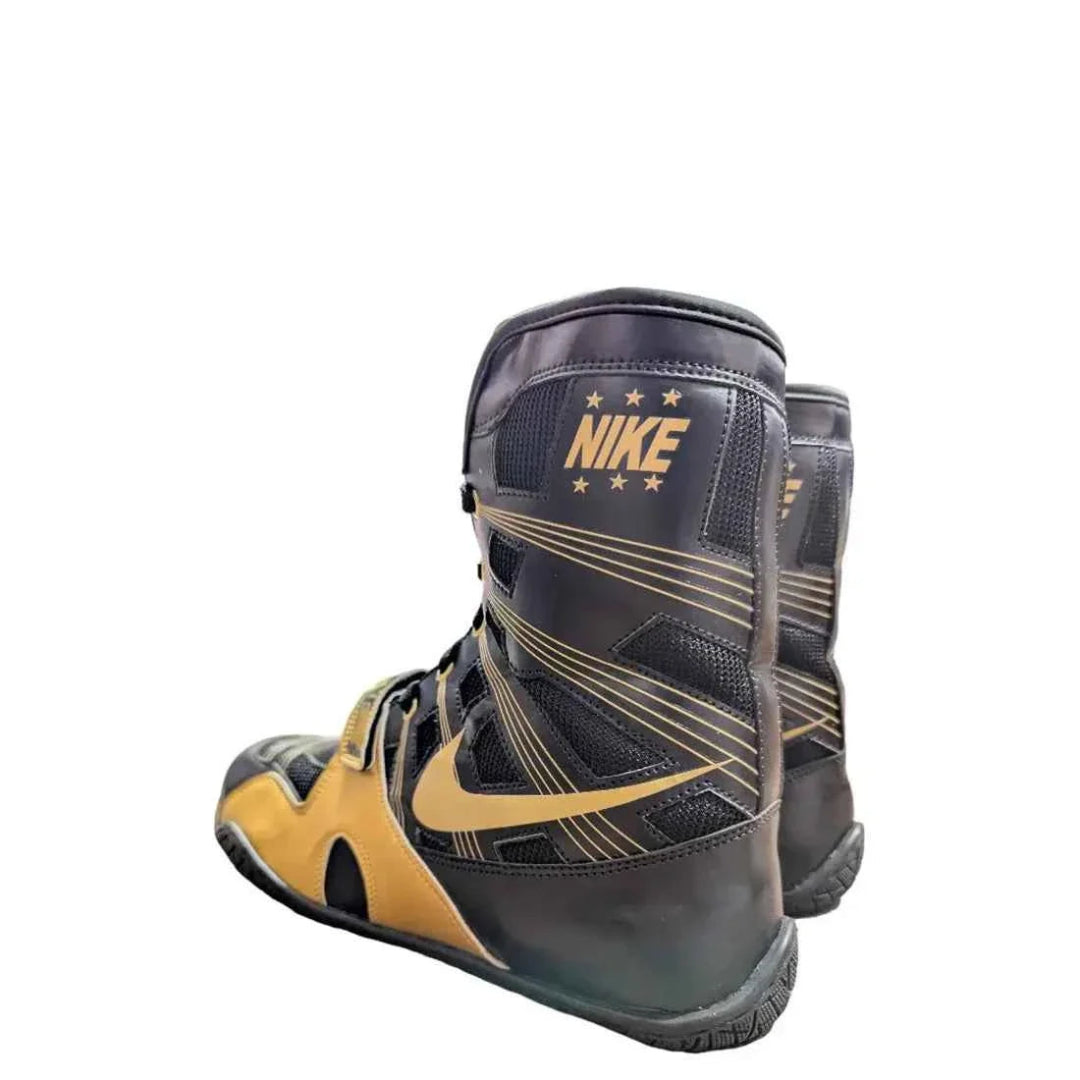 Black and gold Nike boxing boots on a white background