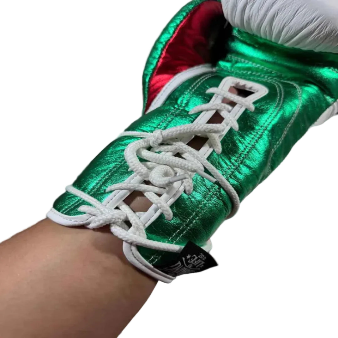Green and red sneaker with white laces held by a person against a blurred background