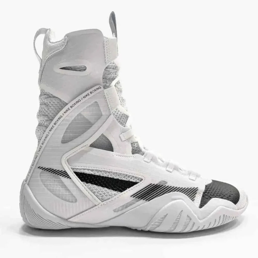 A high-top athletic sneaker in white, gray, and black, featuring a textured mesh and synthetic upper with a lace-up closure, shown from a side profile on a light gray background.