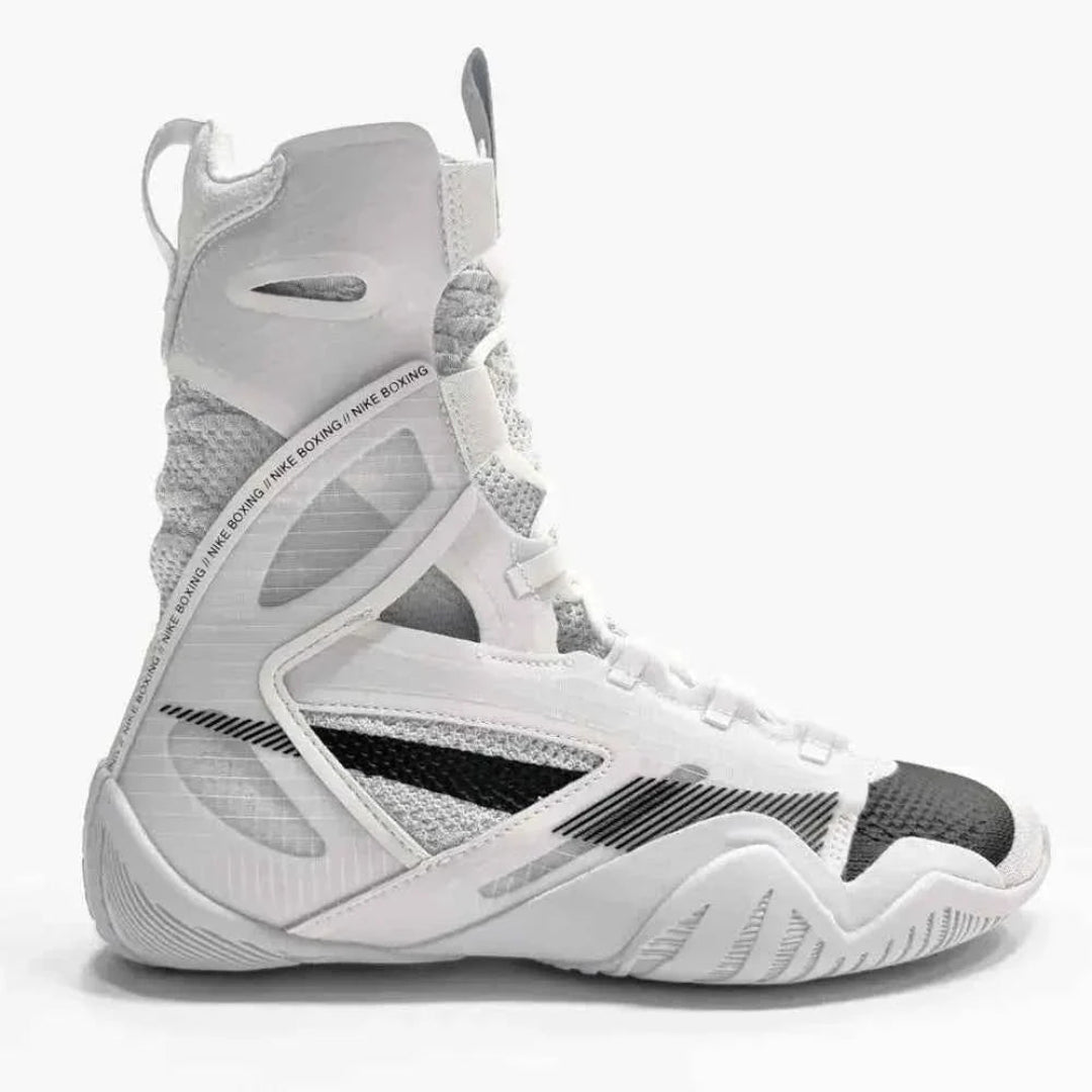 A high-top athletic sneaker in white, gray, and black, featuring a textured mesh and synthetic upper with a lace-up closure, shown from a side profile on a light gray background.