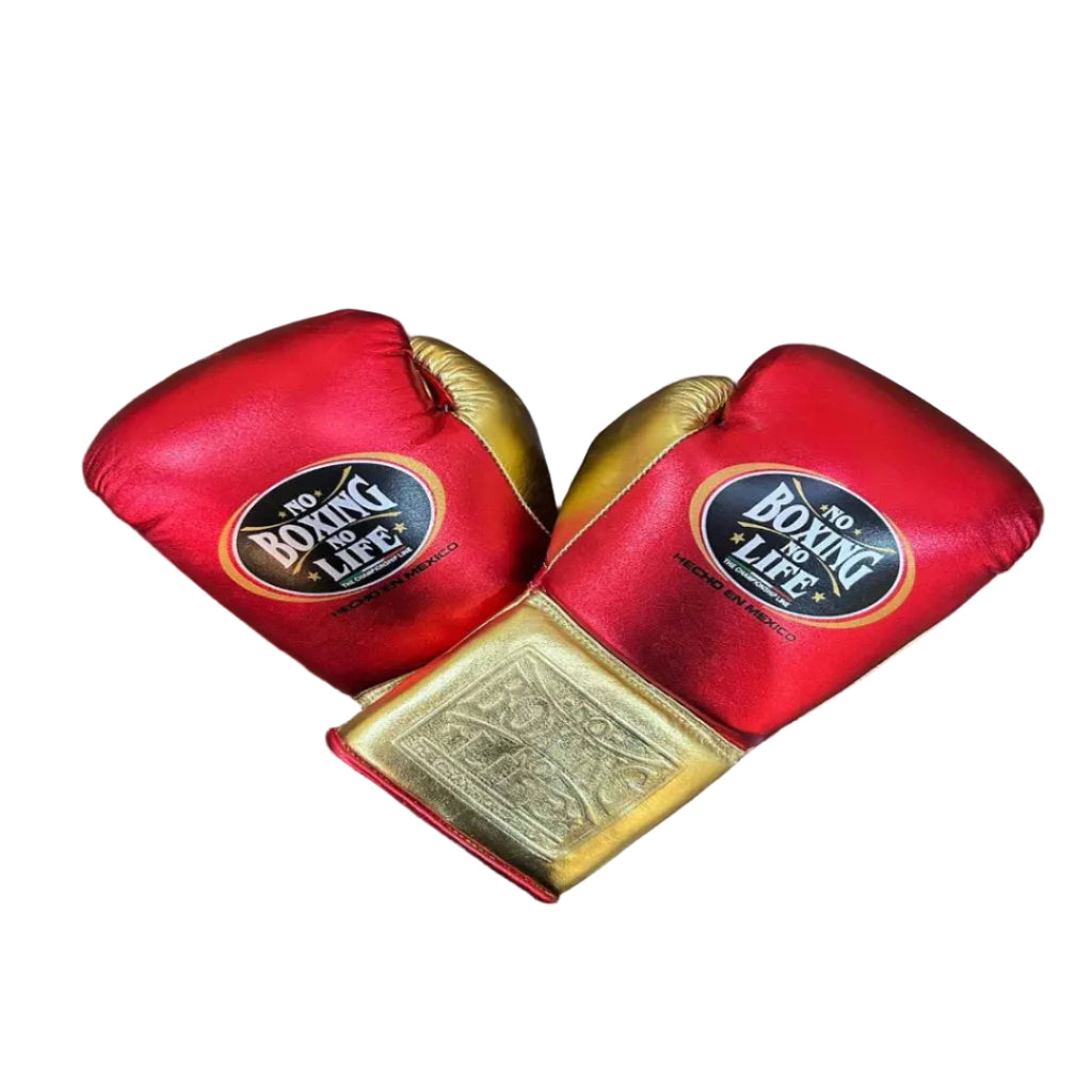 Red boxing gloves with gold accents on a wooden surface