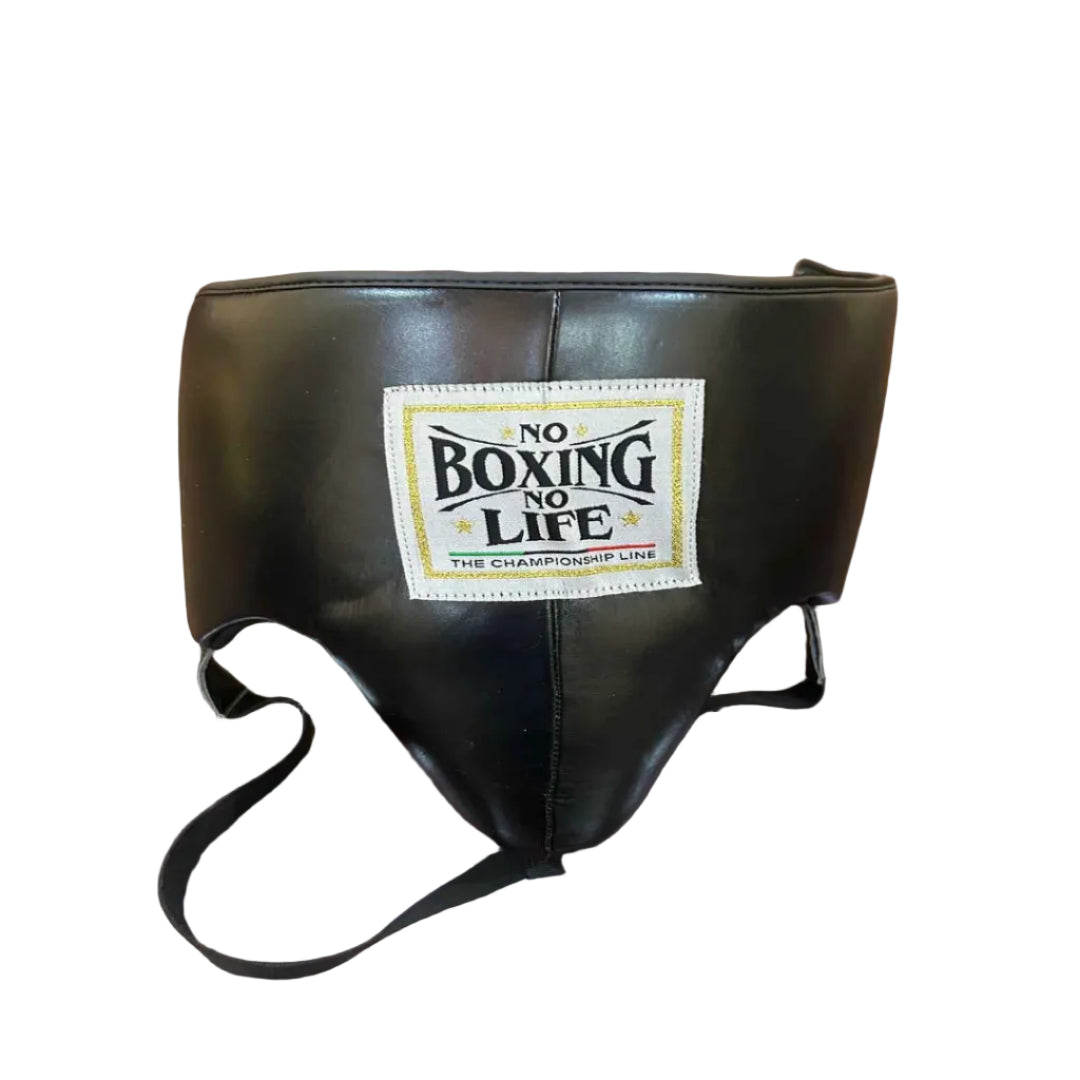 Black boxing headgear with a visible label on a wooden surface
