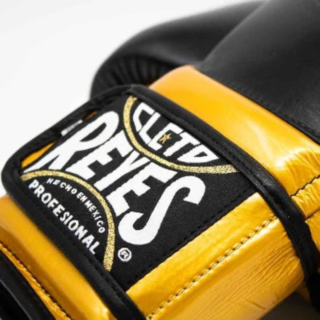 Close-up of a yellow boxing glove with 'Cleto Reyes' branding on a white background