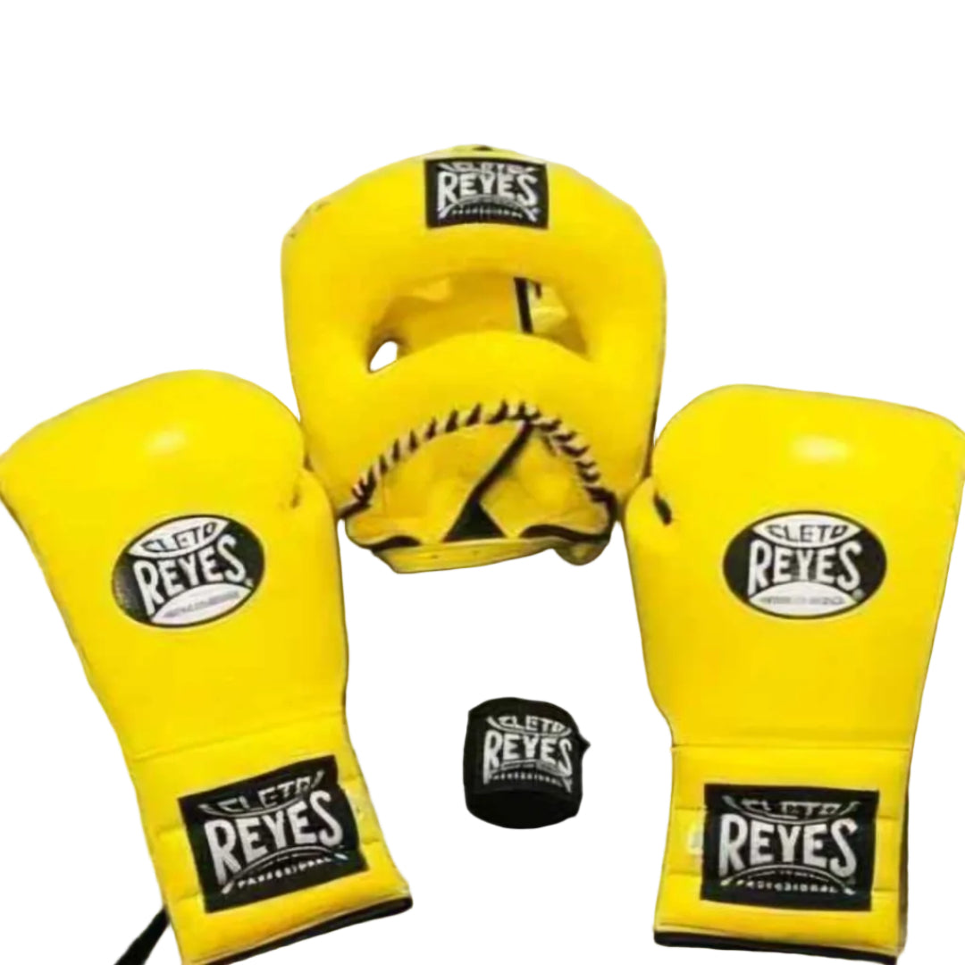 Yellow boxing gloves with 'Sleto Reyes' branding on a gray wooden floor.