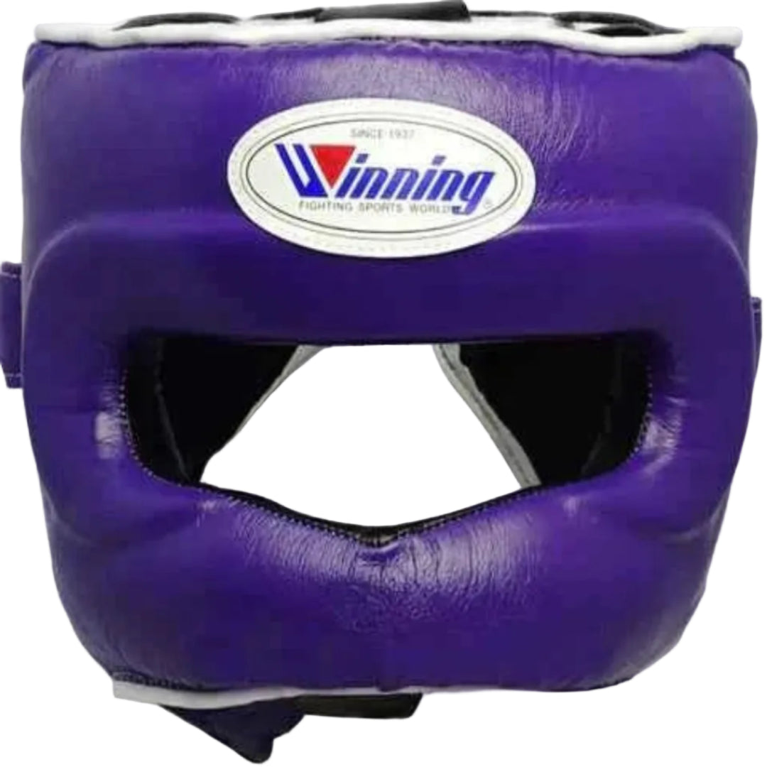 A purple boxing headguard with a white and blue Winning logo patch on the forehead, shown against a plain white background.