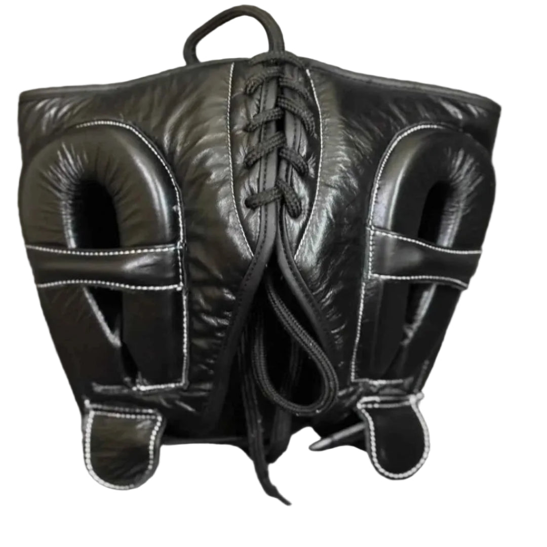 Pair of black leather boxing mitts on a gray surface