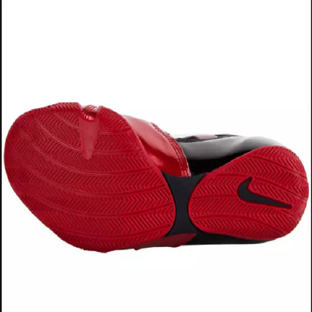 Red and black Nike shoe sole showing the outsole tread pattern and a black Nike Swoosh on a white background.