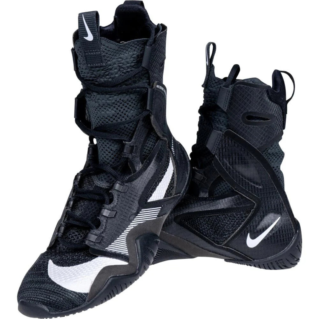 A pair of black Nike high-top athletic boots with white swoosh logos and white textured side stripes, shown on a plain white background.