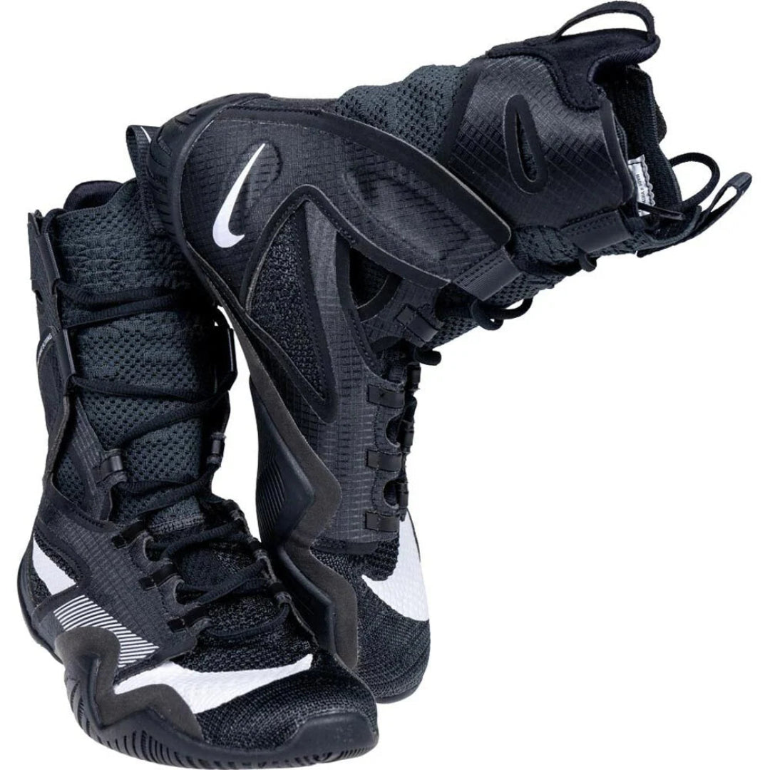 A pair of black Nike athletic sneakers with white swoosh logos, shown against a plain white background.