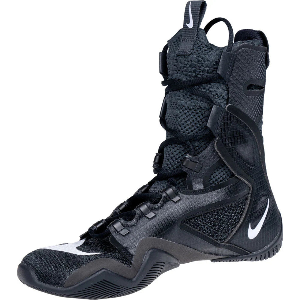 A black Nike high-top basketball boot with white swoosh logos, featuring a mesh and synthetic upper, lace-up front, and heel pull tabs, shown on a white background.