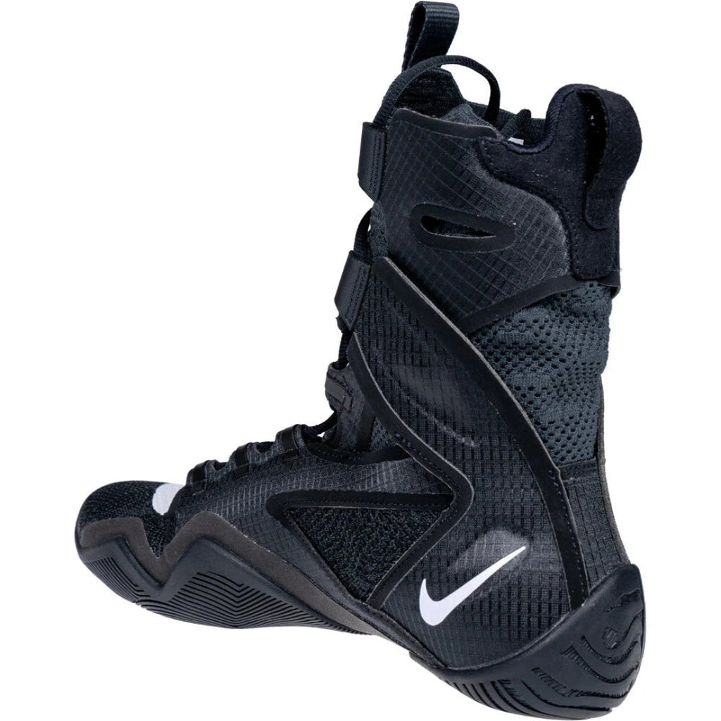 A black Nike basketball boot with a textured mesh upper, black synthetic overlays, and a white Nike Swoosh on the side, shown from a three-quarters angle against a white background.