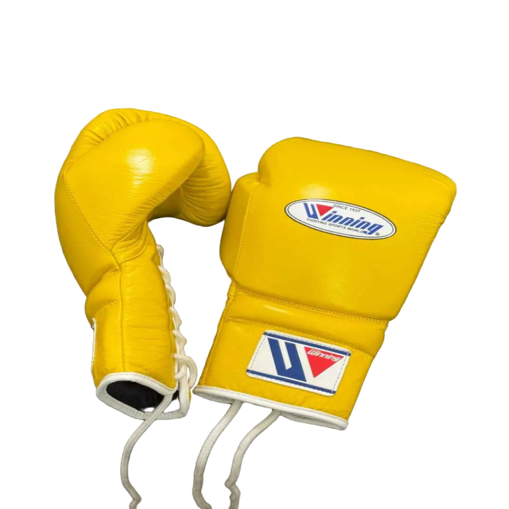 Yellow boxing gloves with a brand logo on a black surface