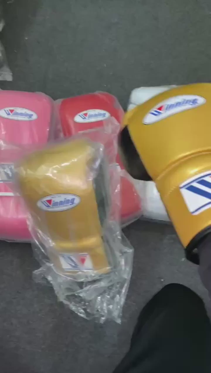 Pink boxing gloves with a visible brand logo on a white background